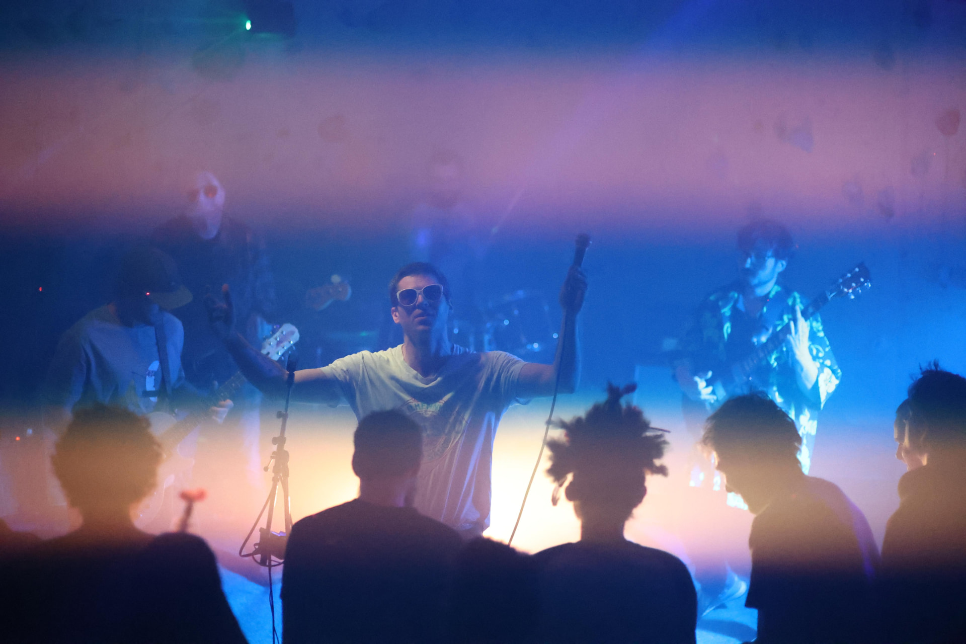 Chango Monks playing to a crowd under blue lights