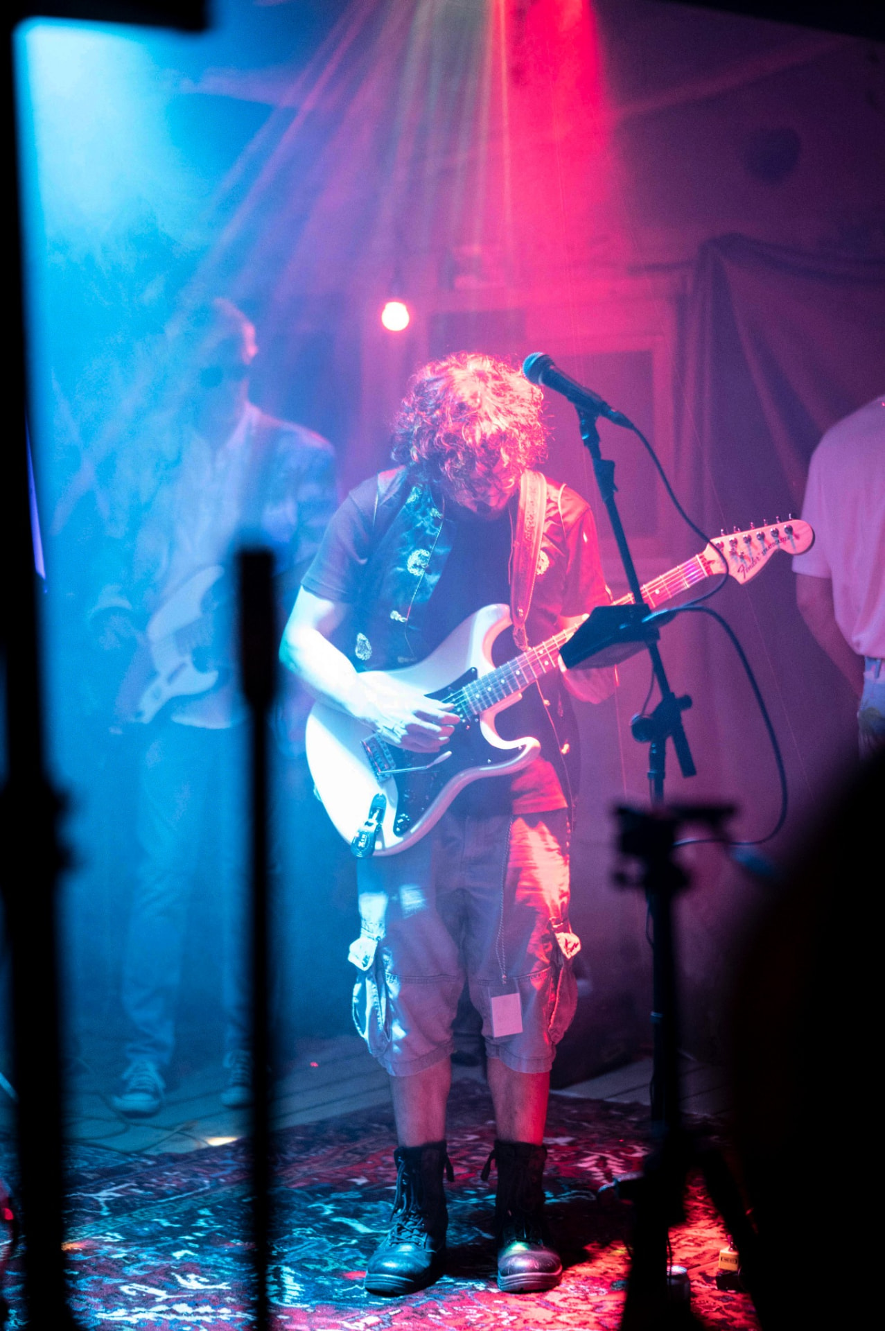 Chango Monks guitarist in red and blue stage fog